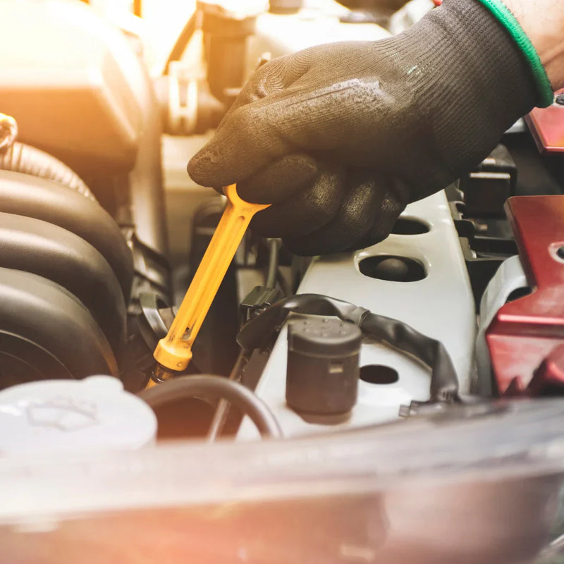 Mechanics Hand Working On Engine