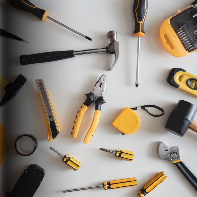 Assorted hand tools including a hammer, screwdriver, wrench, and tape measure.